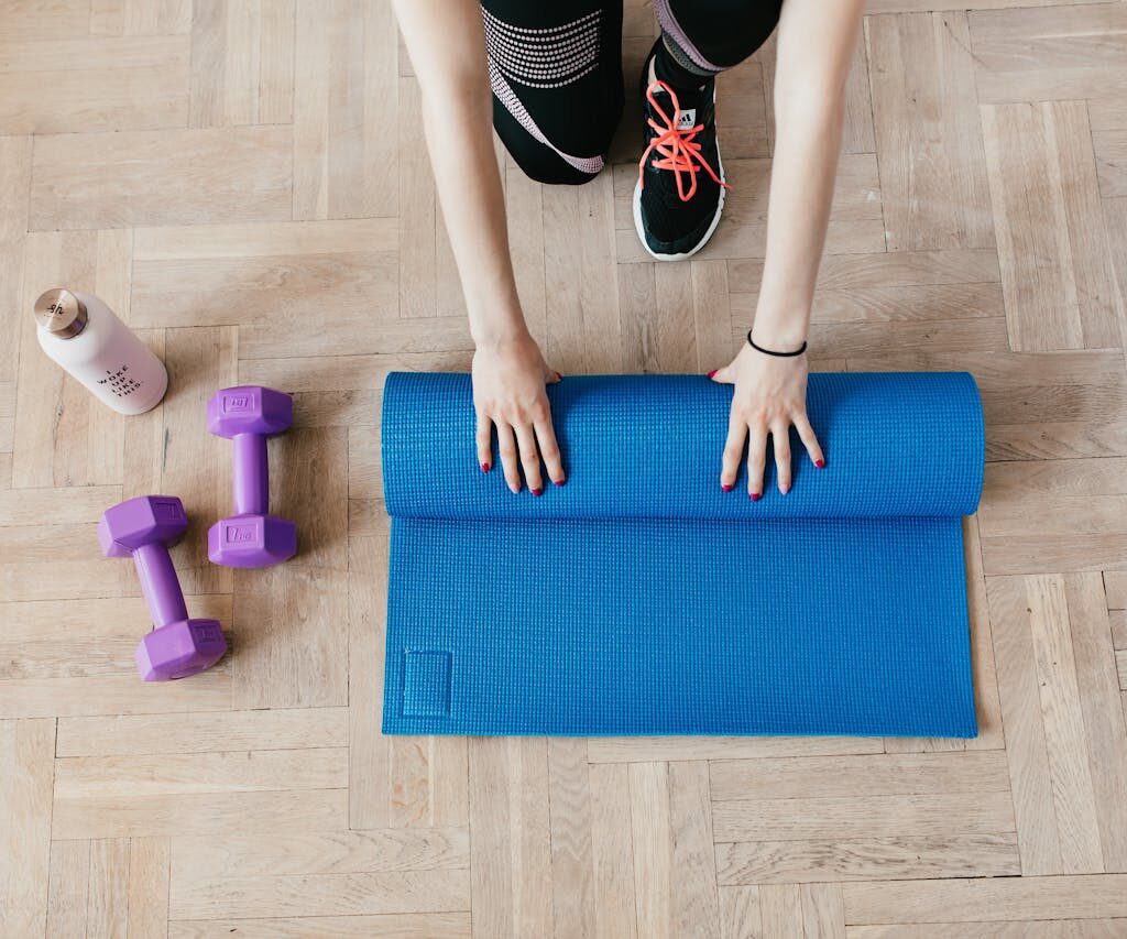 girl unrolling exercise mat